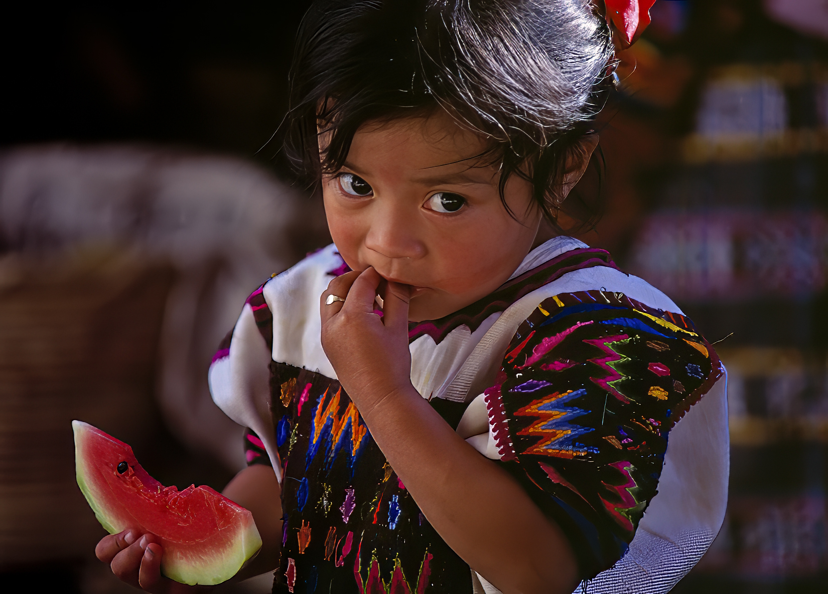 Mayan Girl eating a Watermelon. Chichicastenango (El Quiché) Guatemala.